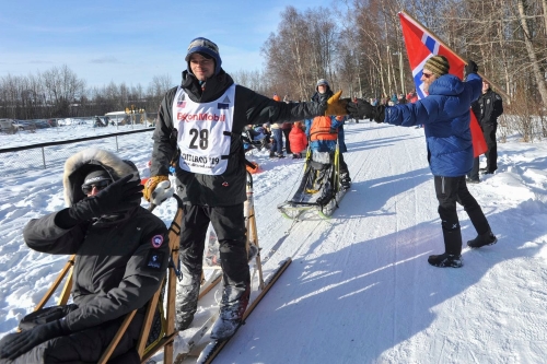 Defending champion Joar Leifseth Ulsom is greeted by local fan Ole Andersson during the ceremonial start of the Iditarod Trail Sled Dog Race Saturday, March 2, 2019 in Anchorage, Alaska. (Michael Dinneen/Associated Press)